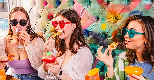 Three friends enjoying the best bottomless brunch in Leeds' funkiest bar - Cuckoo